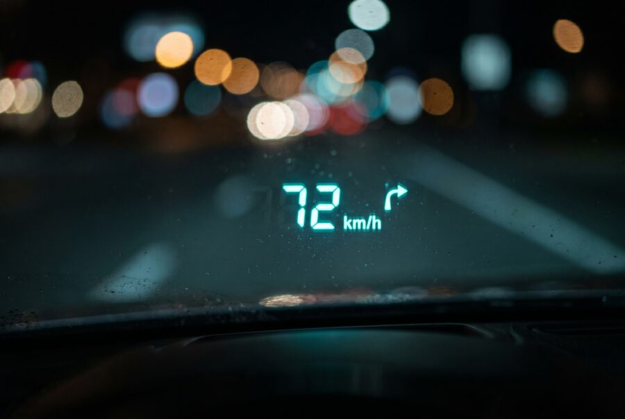 Close-up of a crisp cyan head-up display projection on car windshield glass